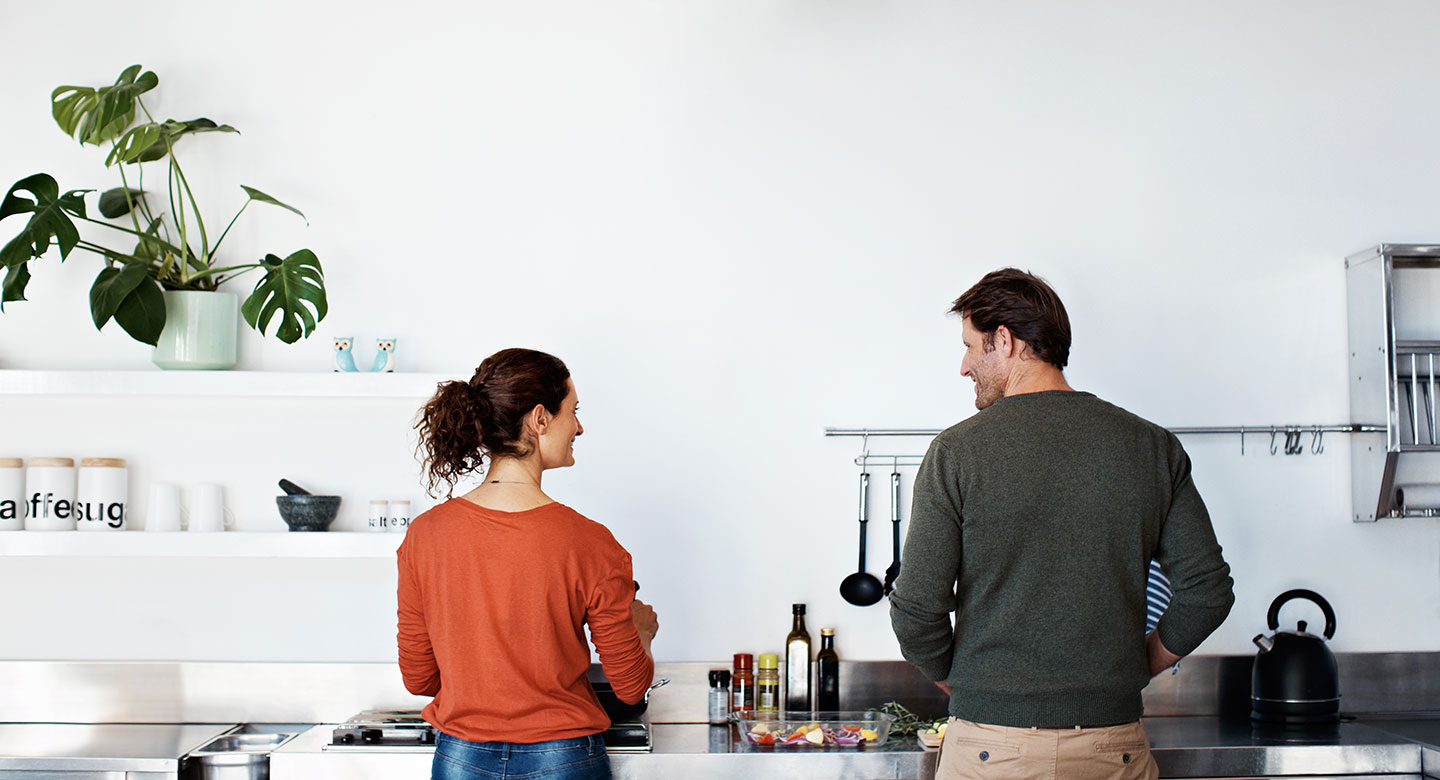 Happy couple cooking in newly renovated kitchen
