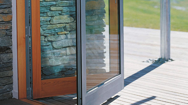 outer light grey joinery with inner timber joinery on glass accordion door