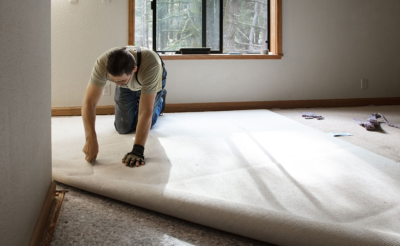 Man Laying a Carpet
