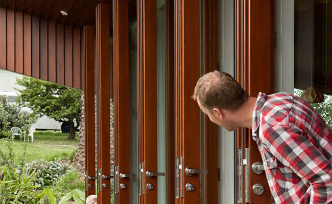 dark coloured timber joinery for several accordion glass doors 