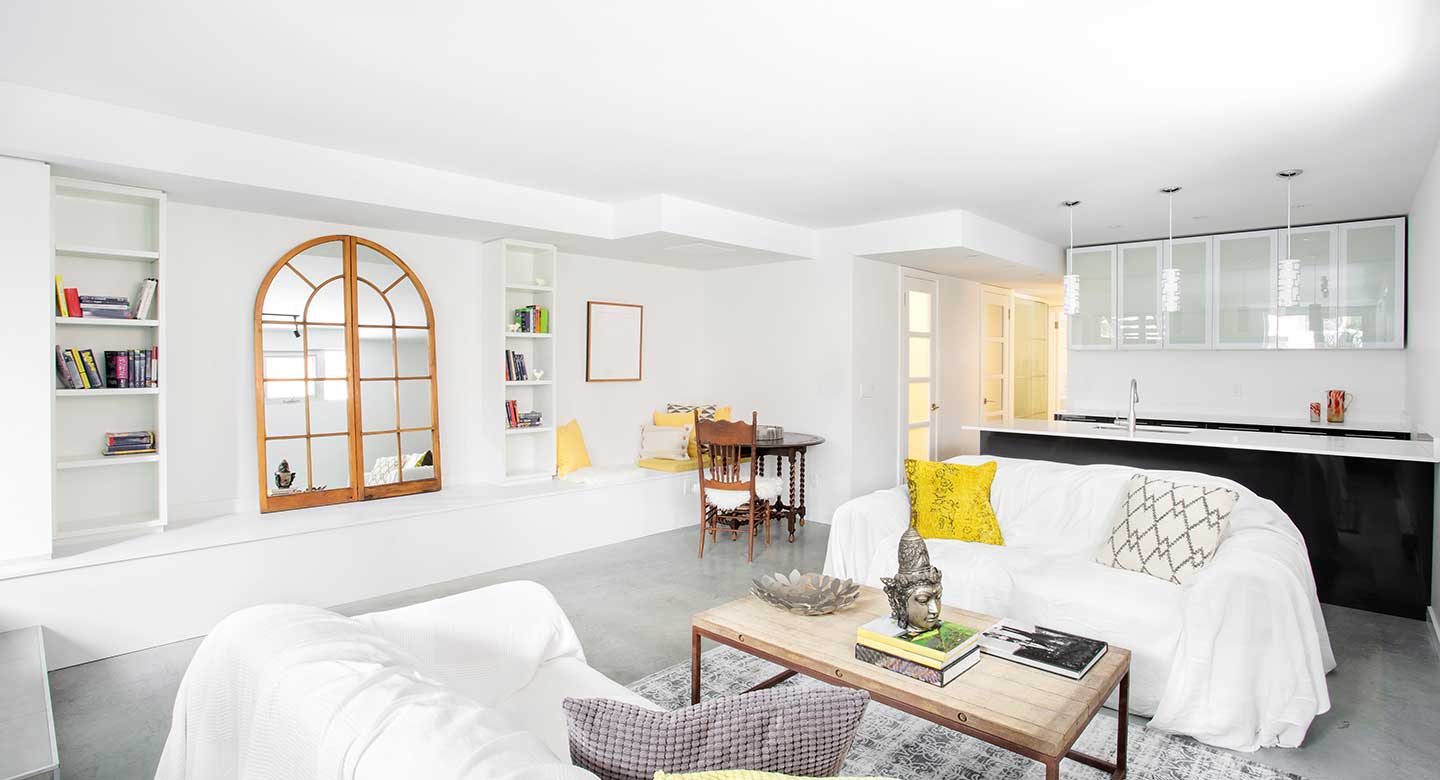 Completed basement remodel fully furnished with an added kitchen with pendant lighting.