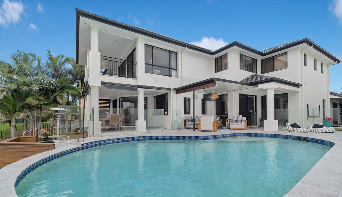 House exterior with large turquoise pool