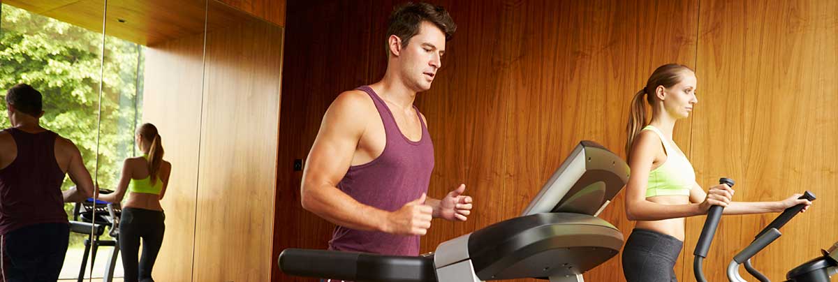 Couple running on a treadmill in a Home Gym