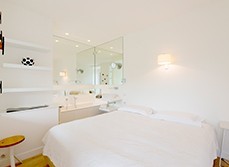 the bedroom with free standing bathtub