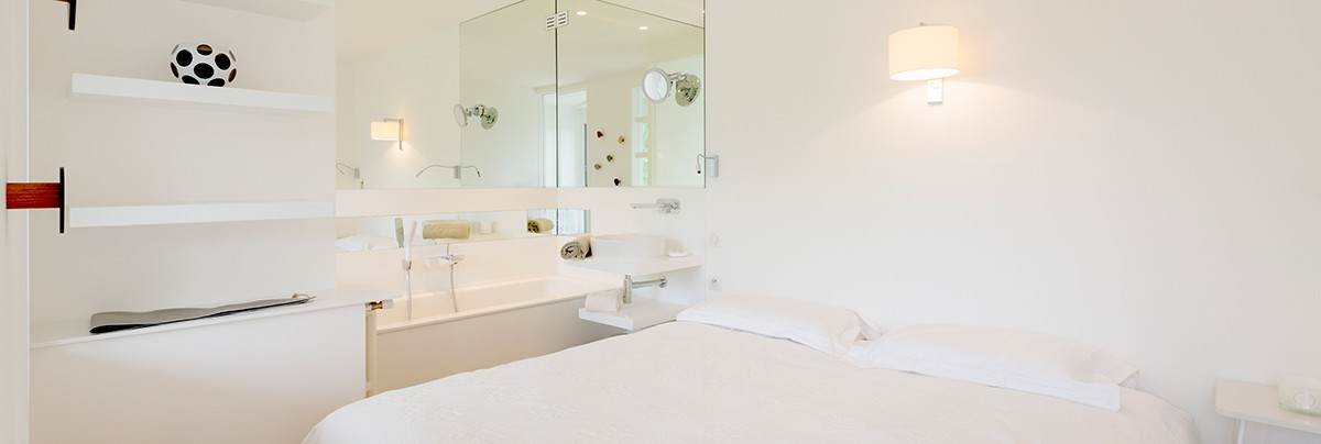 the bedroom with free standing bathtub