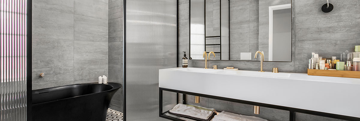 Gray tile bathroom with gold fixtures