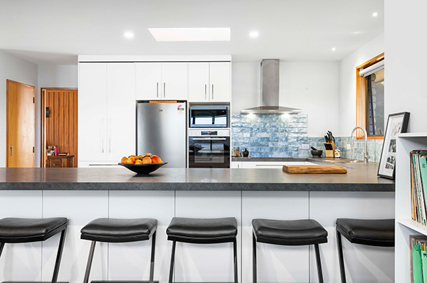 This 1980s property was renovated to modernise its dated interiors with an open-plan layout and make the most of the lakeside views.