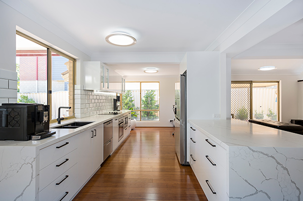 Intensive structural work was required to take the ground floor of this Maylands townhouse from dark and disjointed to bright and open.