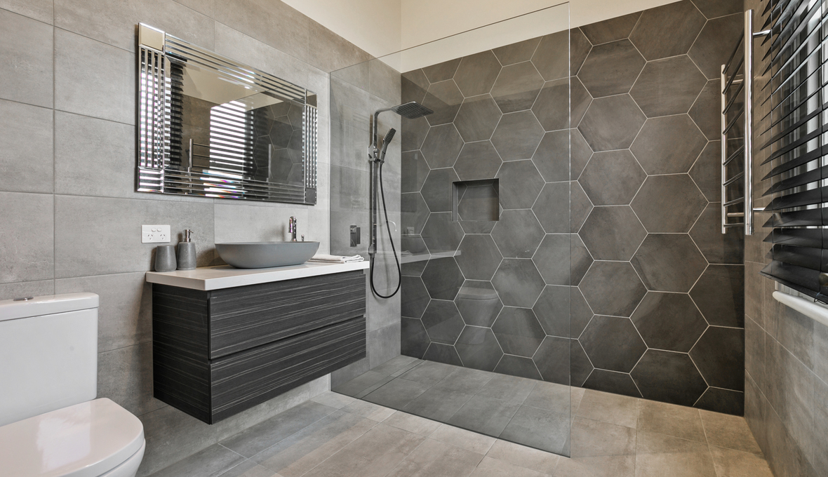 Bathroom remodeling in League City, TX, with a wall-hung vanity featuring an oval basin.