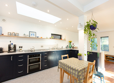 A large open plan kitchen and living area that overlooks the garden