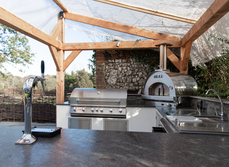 A view from the side of the outdoor kitchen showing the appliances