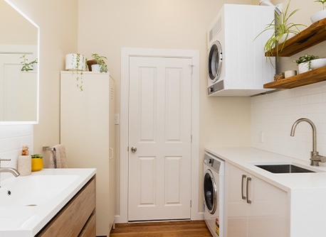 Laundry and bathroom with white bench tops