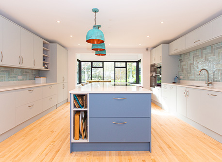 Open kitchen space with blue stand-alone kitchen island