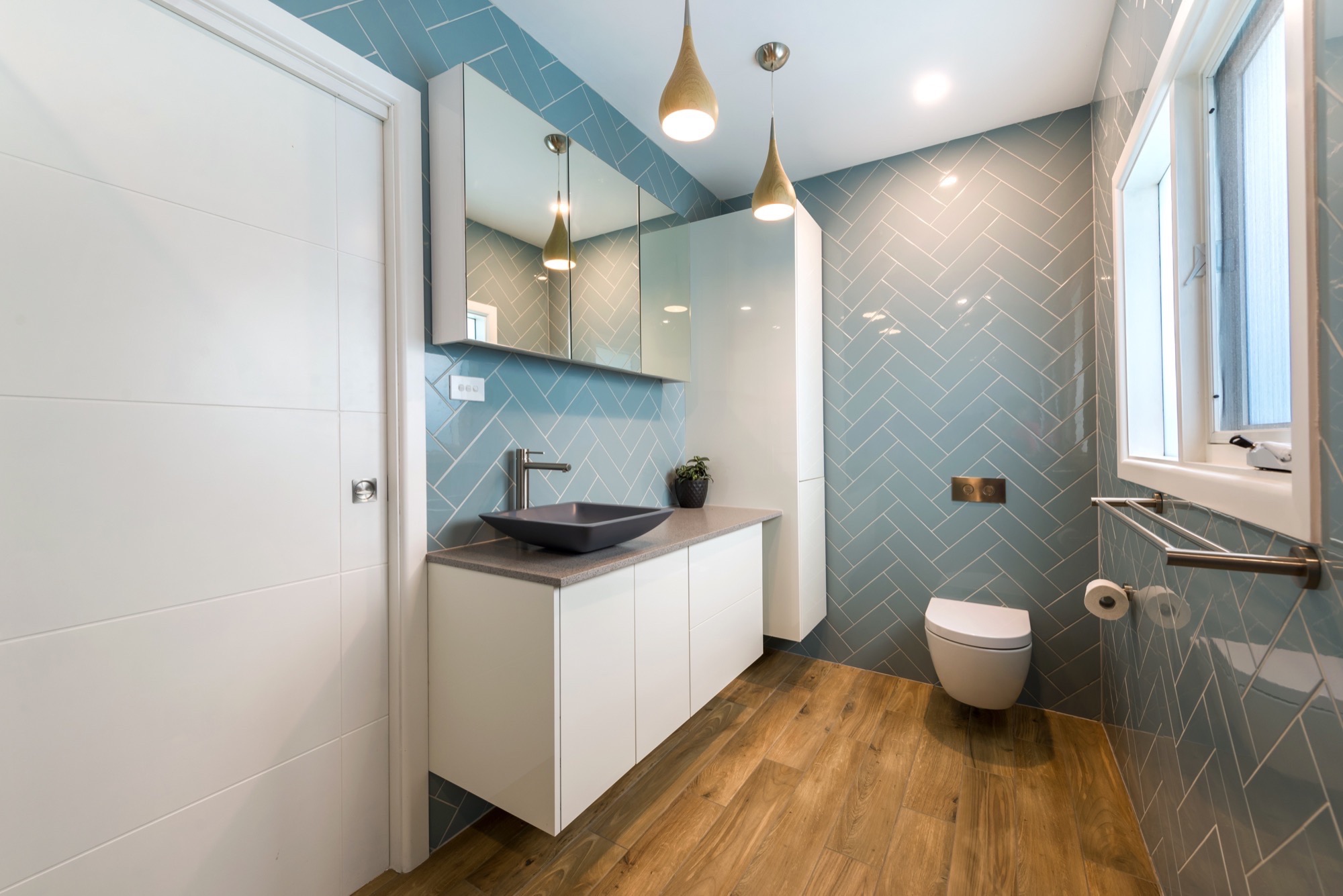 Chevron blue tiling in this bathroom remodel