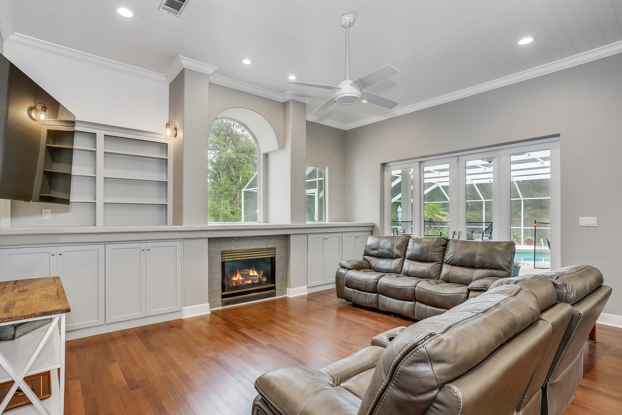 lounge addition with a fireplace and built-in shelves