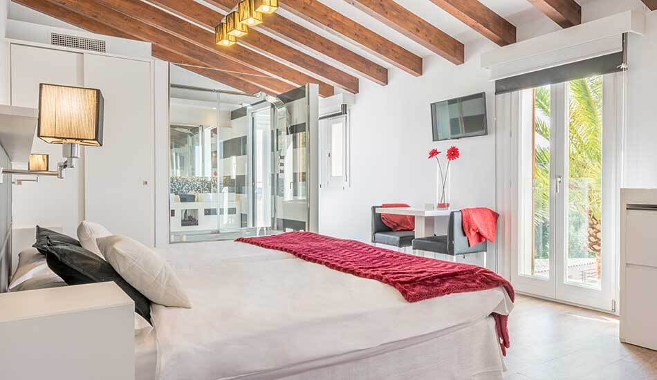 guest room sloped ceilings with timber beams and glass door