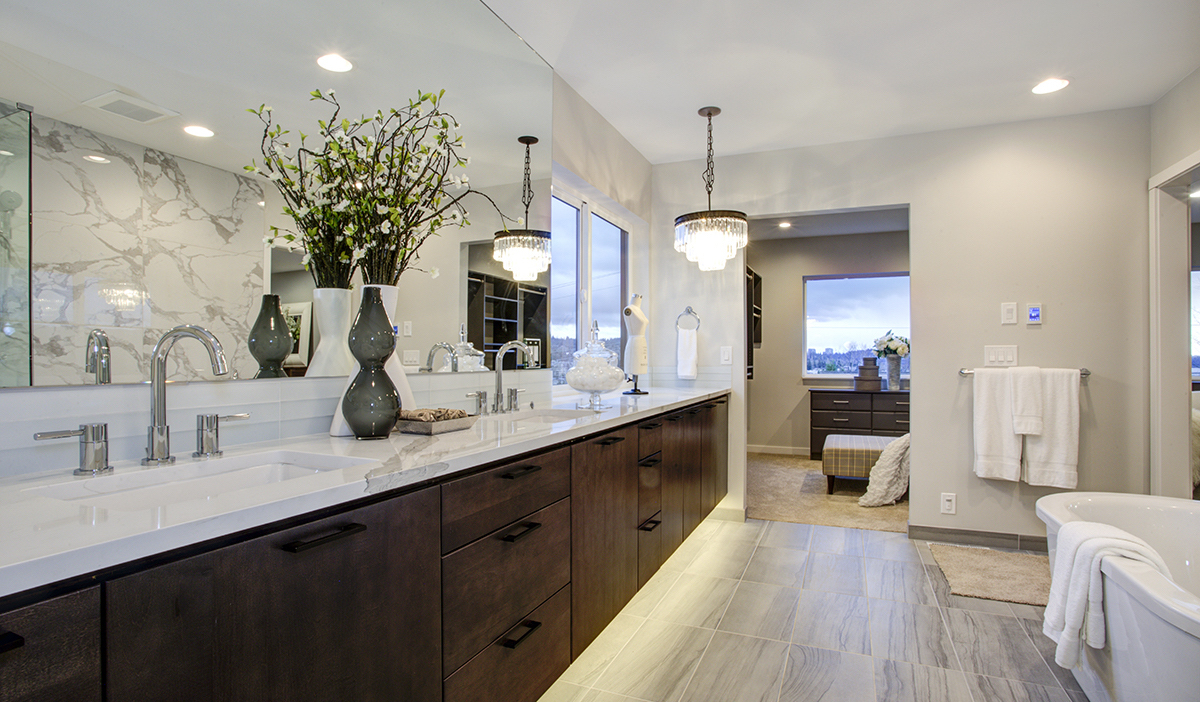 high end bathroom with marble vanity top and dark wooden cabinets