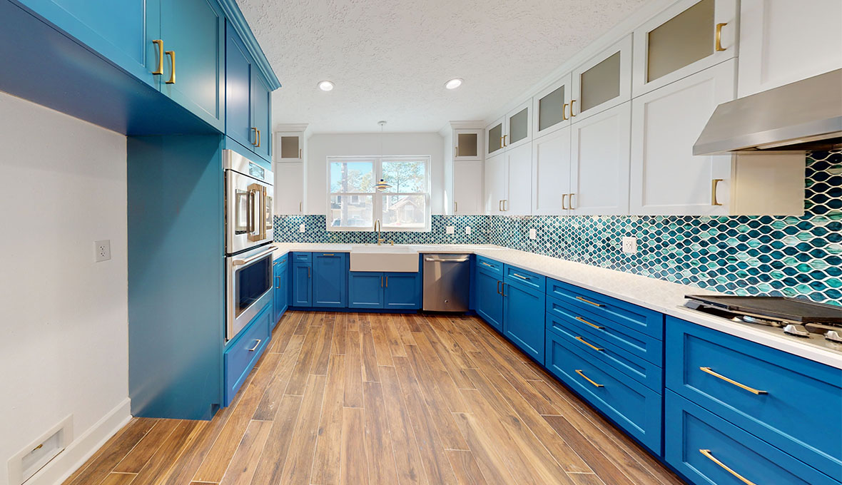 Our completed kitchen from our home remodeling contractors in sugar land which gesture blue draws with golden handles
