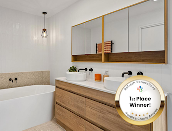 Bathroom with floor to ceiling tiles and double vanoty