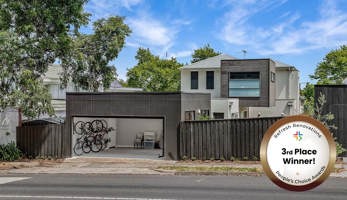 Box shaped house with bronze badge in the corner